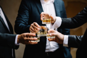 Group of men toasting each other with drinks