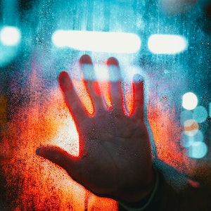 hand against glass